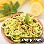A brown bowl filled with Lemon Herb Zucchini Noodle Salad.