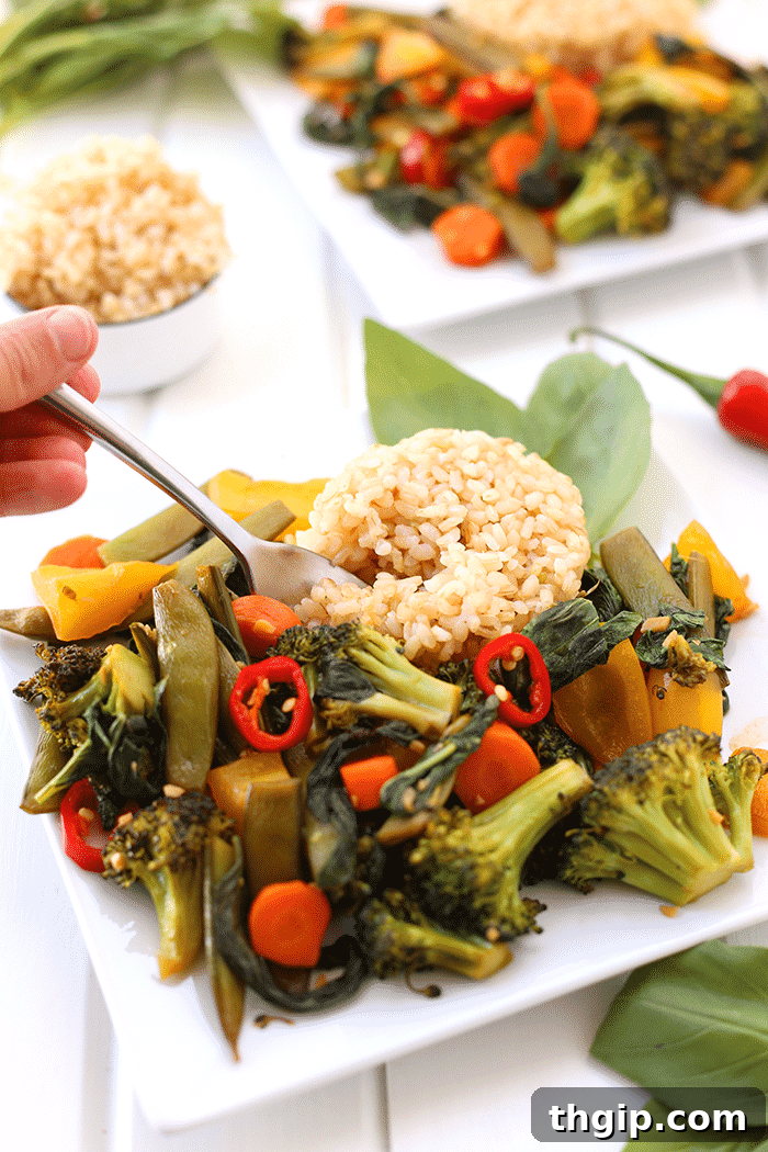 An appetizing overhead shot of a perfectly cooked Thai Basil Vegetable Stir Fry in a skillet.