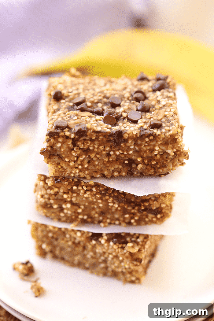 Morning Fuel Banana Quinoa Bars 3 Close-up of a stack of banana quinoa breakfast bars with chocolate chips, ready to eat.