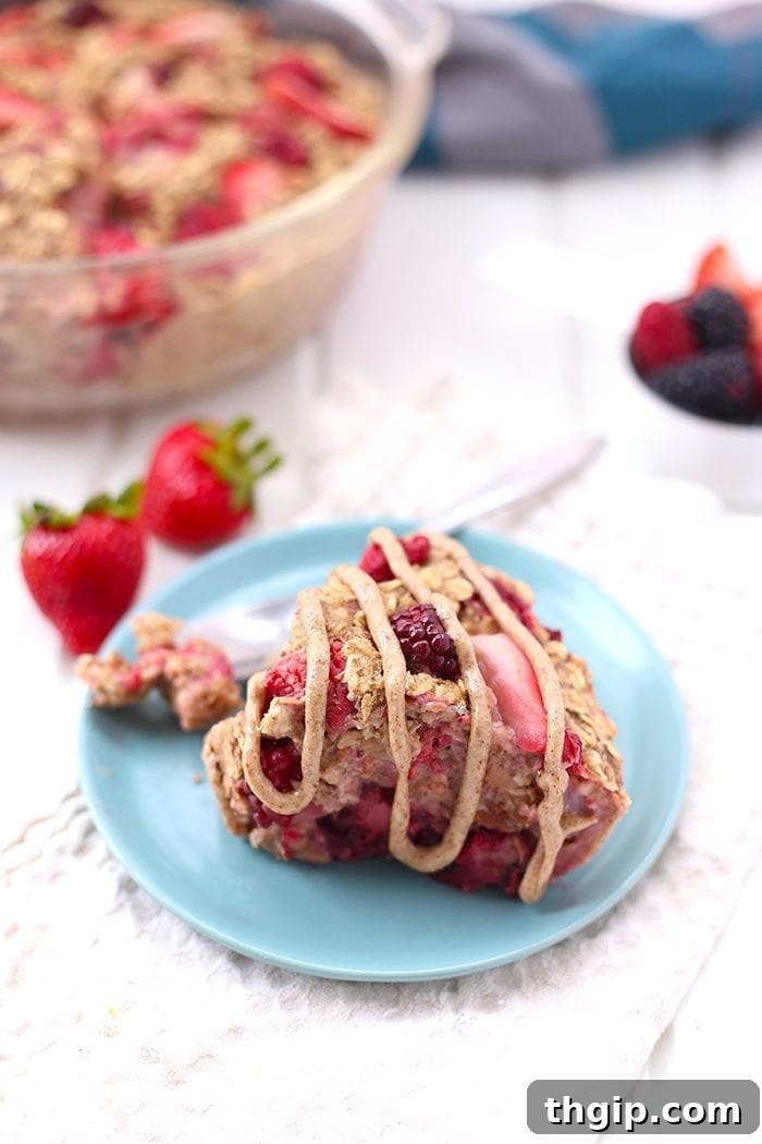 Berry Burst Baked Oatmeal 2 A beautifully presented dish of Triple Berry Baked Oatmeal, topped with fresh berries, showcasing a healthy, gluten-free, and vegan breakfast option.