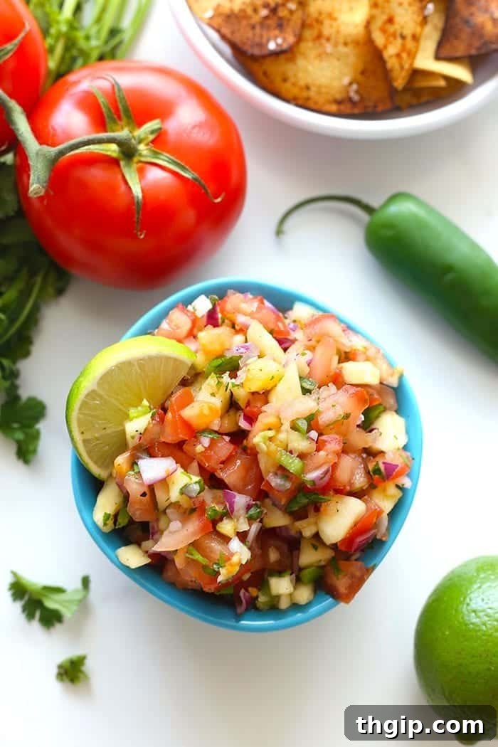A serving of grilled fish topped generously with fresh sweet and spicy pineapple salsa and cilantro.