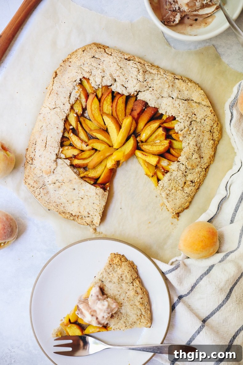 Rustic Vegan Peach Galette 3 A close-up of thinly sliced fresh peaches mixed with spices, ready for the galette filling.