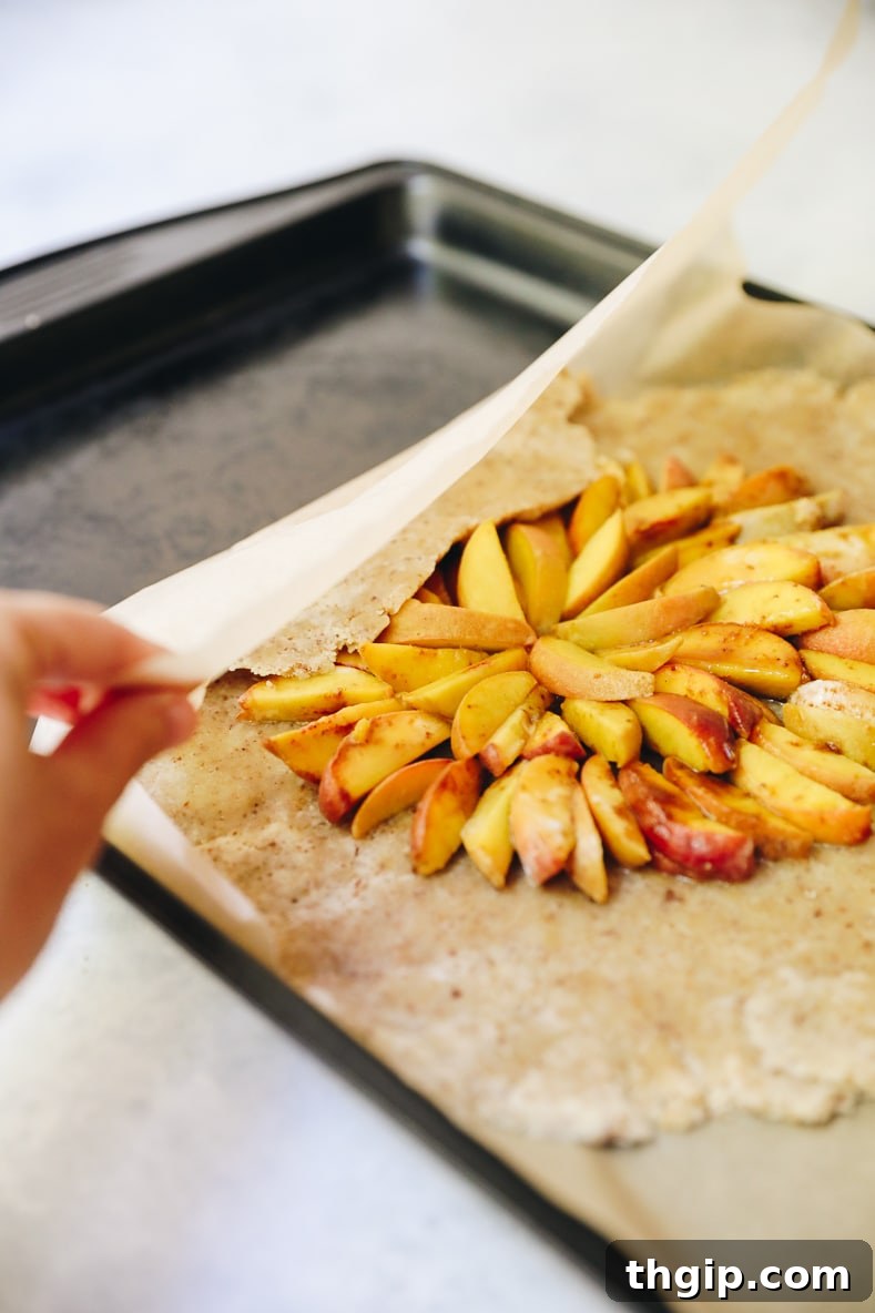 Rustic Vegan Peach Galette 6 The assembled vegan peach galette, with crust folded around the sweet peach filling, ready for baking.