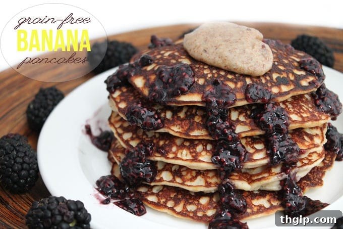 Fluffy Grain-Free Banana Protein Pancakes Stacked with Syrup