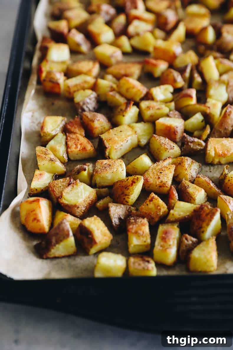 Crispy Roasted Potatoes: Two Mouthwatering Variations 4 Crispy roasted potatoes arranged on a baking sheet, golden and perfectly browned.