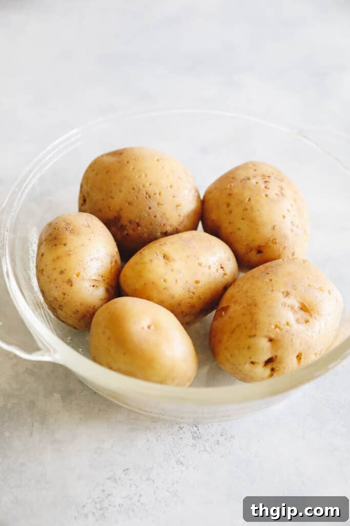 Crispy Roasted Potatoes: Two Mouthwatering Variations 5 Potatoes being microwaved in a bowl for the quick cooking method.