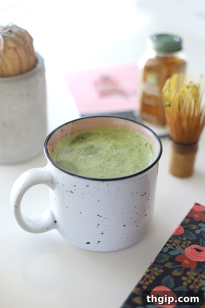 Turmeric Matcha Elixir 5 Third step for Matcha Turmeric Latte: Heating milk in a separate container, adding coconut oil, and preparing to combine with the whisked matcha base.