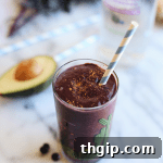 A vibrant green Yoga Glow Smoothie, a nutritious and delicious blend for a radiant start to your day.