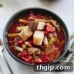 A small bowl of vegetable soup, garnished with croutons.