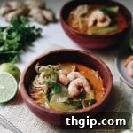 A small image of Curried Thai Coconut Ramen with Shrimp, showing a rich broth and vibrant ingredients.