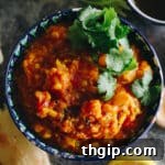 Vegetable dal in a decorative bowl with cilantro garnish.