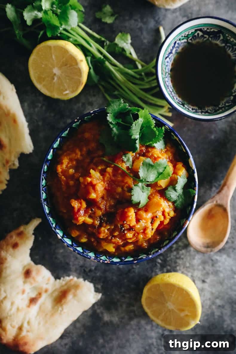 Overhead image of a bowl of root vegetable dal recipe, garnished with cilantro.