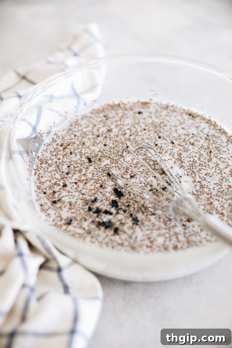 Vanilla Dream Chia Pudding 4 All vanilla chia pudding ingredients being stirred together in a large glass bowl.