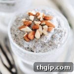 Close up shot of vanilla chia pudding in a glass dish topped with chopped almonds.