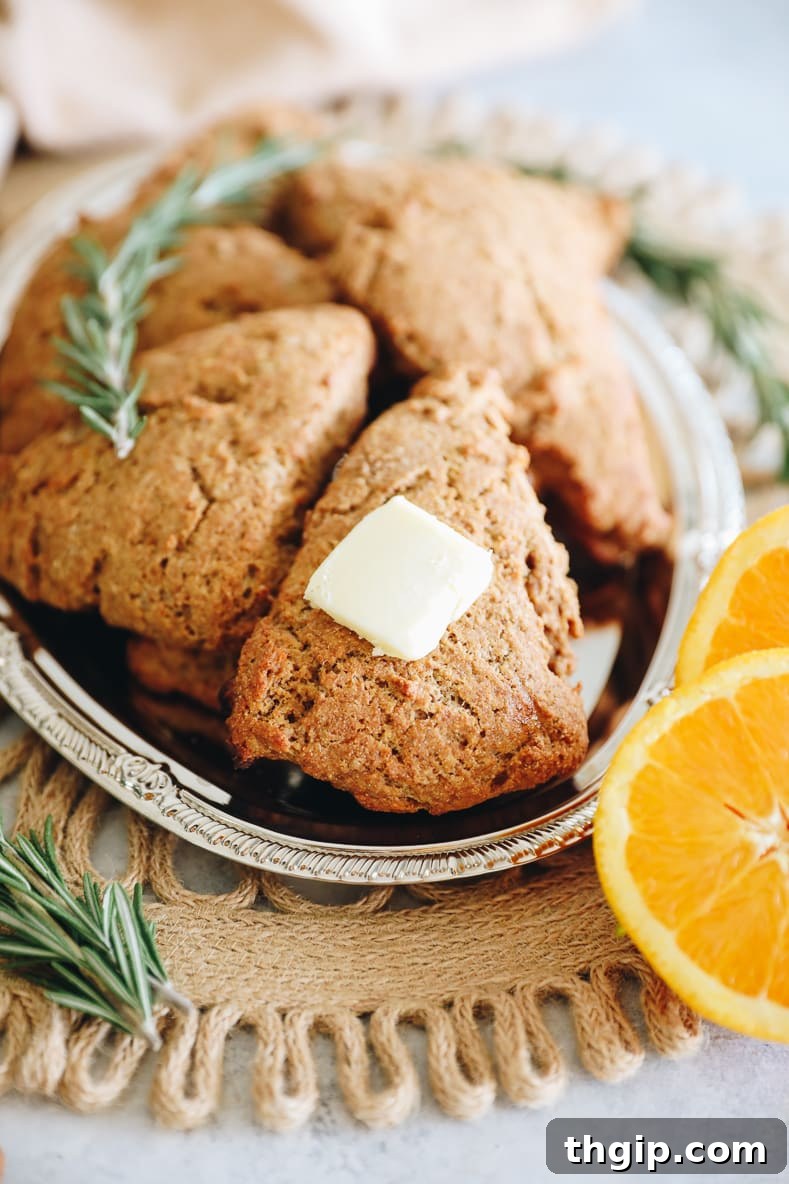 Zesty Orange Rosemary Scones 2 Freshly baked whole wheat orange rosemary scones, golden brown and inviting.