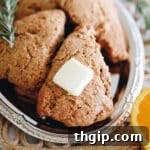 Close up shot of orange rosemary scones served on a silver platter.