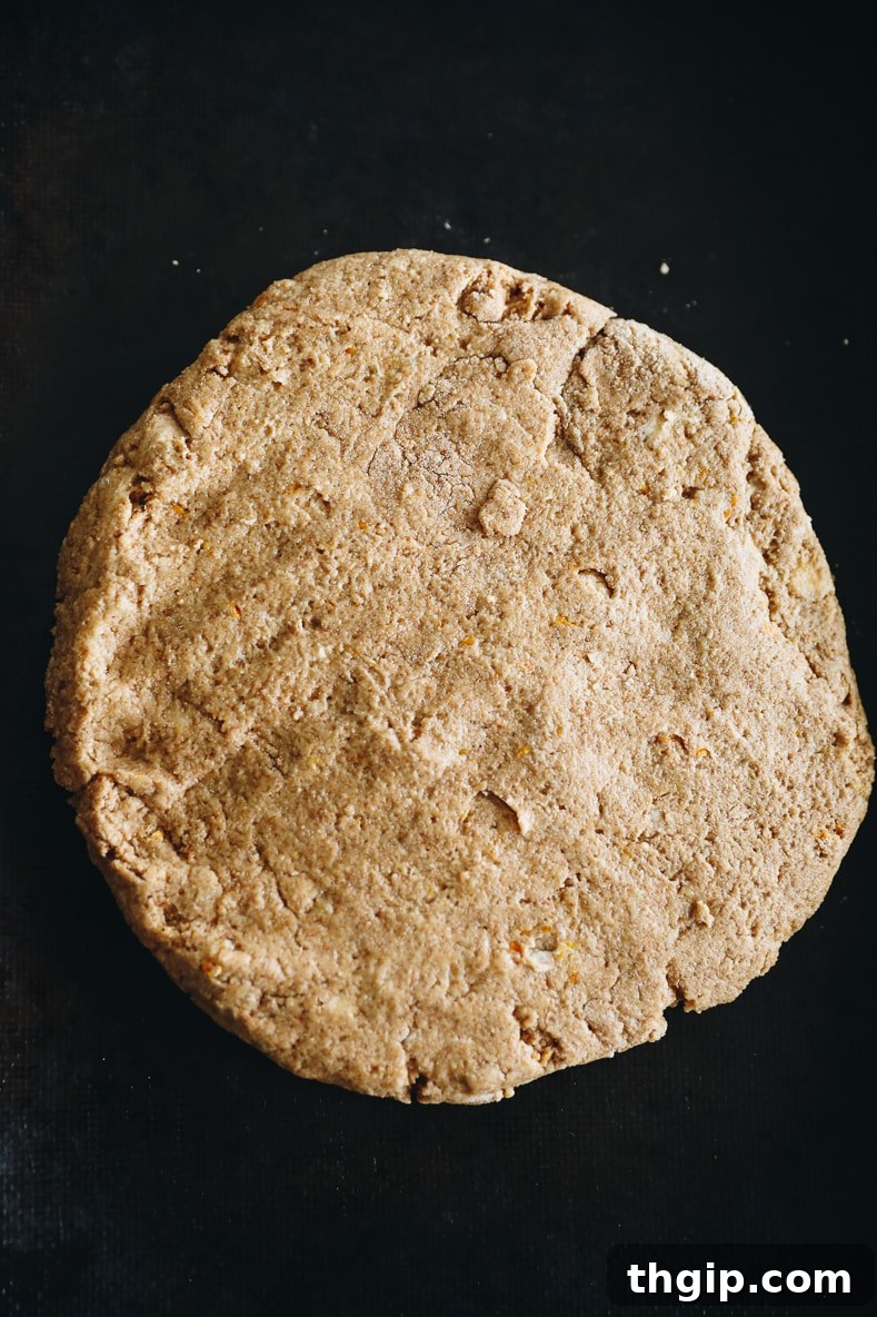 Zesty Orange Rosemary Scones 9 Forming scone dough into a large circle on a parchment-lined baking sheet.