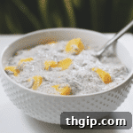 Individual serving of Mango Coconut Chia Pudding with fresh mango pieces.