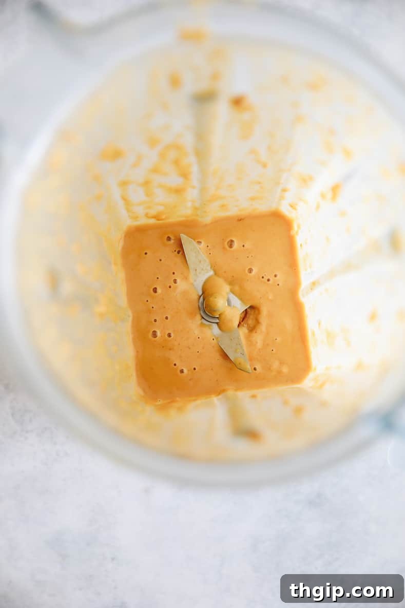 Zesty Thai Turkey Burgers with Peanut Drizzle 3 Peanut sauce ingredients blending in a blender until smooth and creamy.