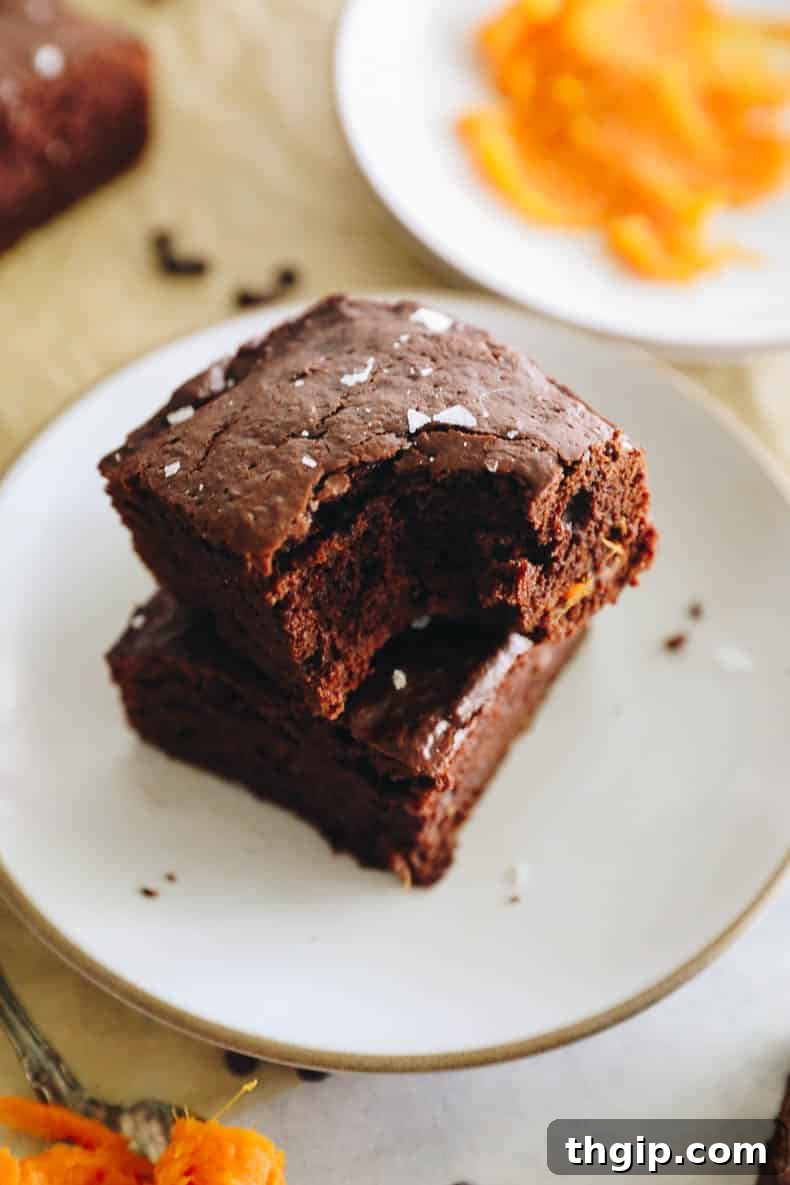Velvety Sweet Potato Chocolate Brownies 3 Close-up of fresh, raw sweet potatoes, highlighting their vibrant orange color and natural textures, ready for preparation.
