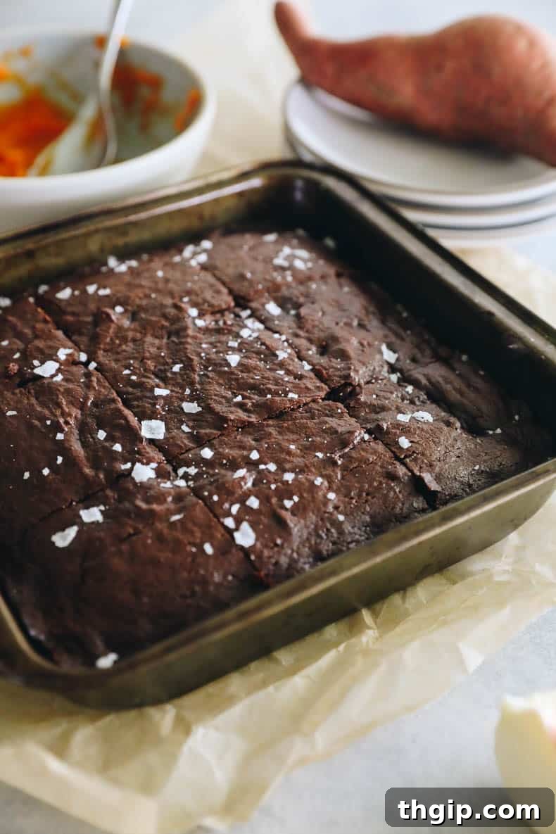 Velvety Sweet Potato Chocolate Brownies 8 Freshly baked sweet potato brownies, cut into 9 perfect squares, still in the baking pan.
