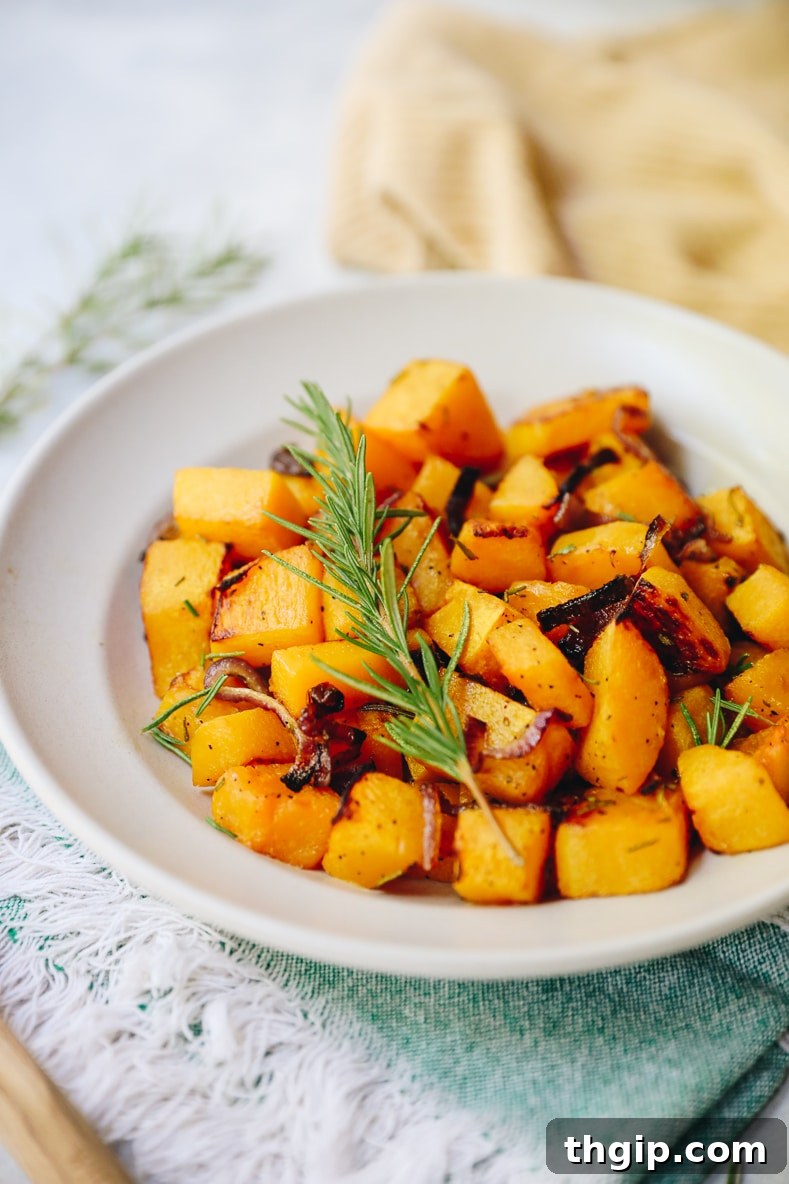 Roasted Rosemary Butternut Squash 5 Close-up of perfectly roasted rosemary butternut squash, golden-brown and tender, in a serving bowl.