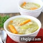 Delicious and easy slow cooker chicken soup with carrots, celery, and herbs