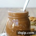 A small jar of Almond Joy Nut Butter with a spoon