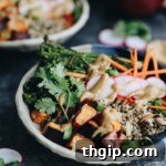 These customizable Quinoa Veggie Bowls with Miso Sesame Dressing will become a weeknight staple. With a quinoa and veggie base topped with a zesty and flavor-packed dressing this easy dinner or lunch recipe is a healthy vegan option for the whole family.