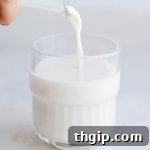 Homemade oat milk in a glass jar, ready to be served or stored.