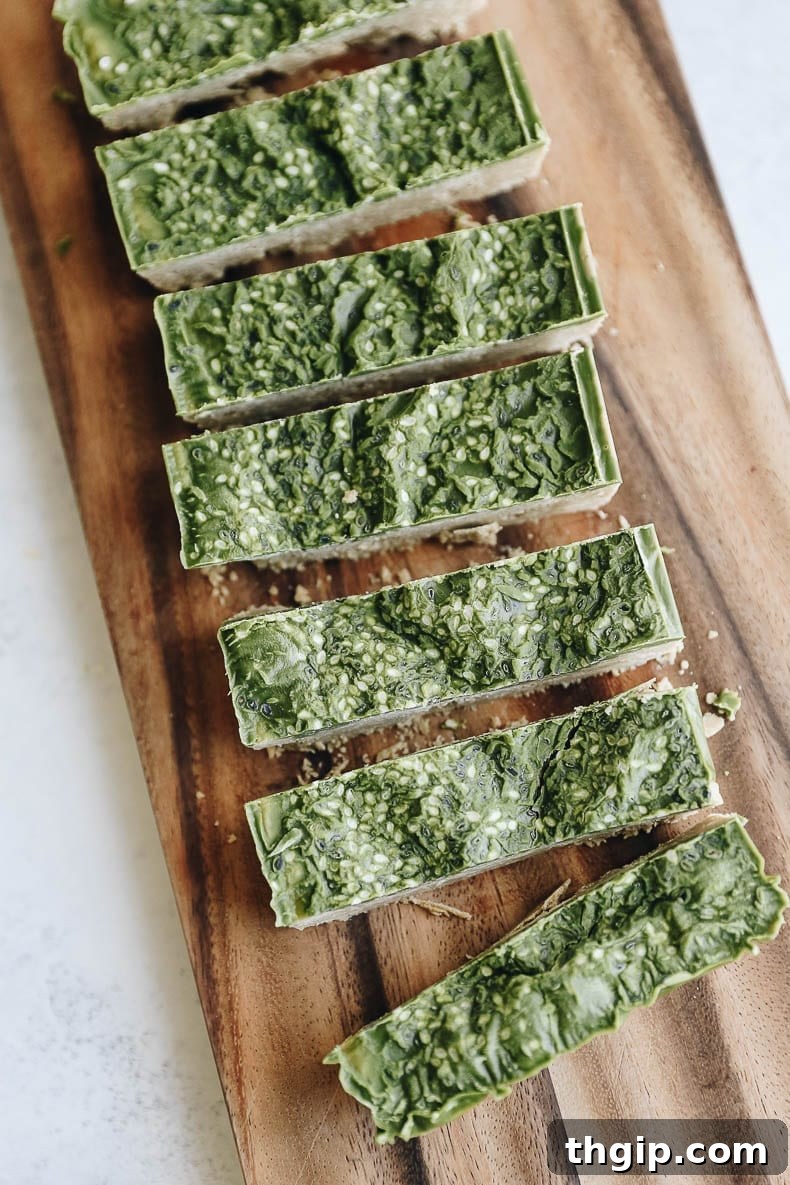 Homemade Matcha Protein Bars with a creamy cashew base and vibrant green matcha frosting, perfect for a healthy, energizing, and vegan snack on the go.