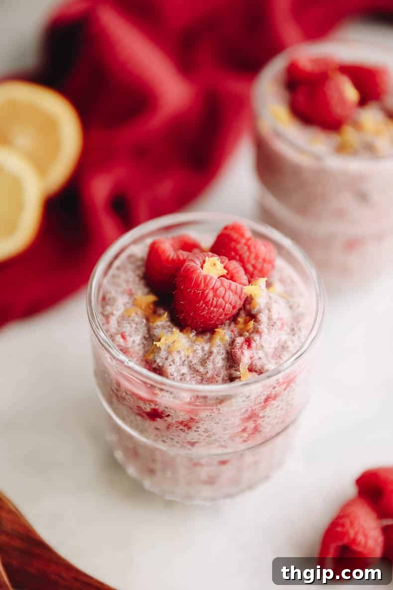 Refreshing Lemon Raspberry Chia Pudding 2 Two glass jars filled with creamy Lemon Raspberry Chia Pudding, topped with fresh raspberries and lemon zest, ready for a nutritious meal or healthy dessert.