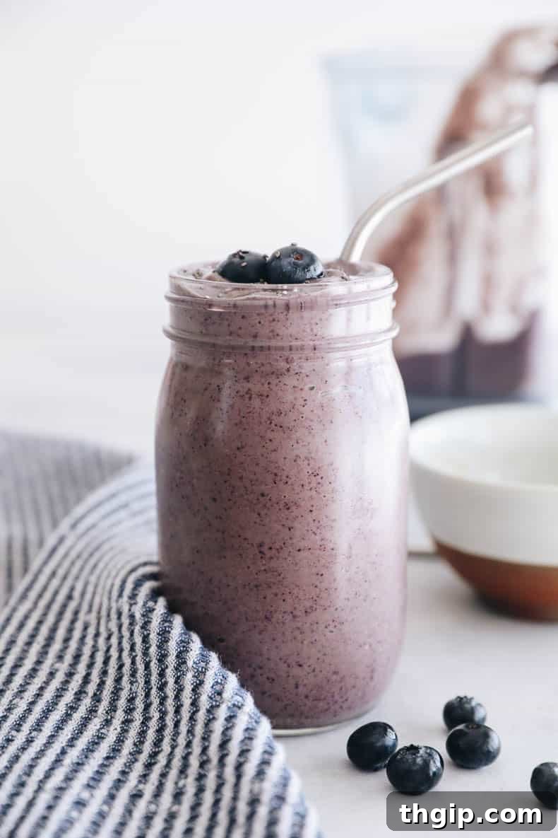 Beautifully presented blueberry superfood smoothie in a clear glass, ready to be enjoyed as a healthy breakfast.