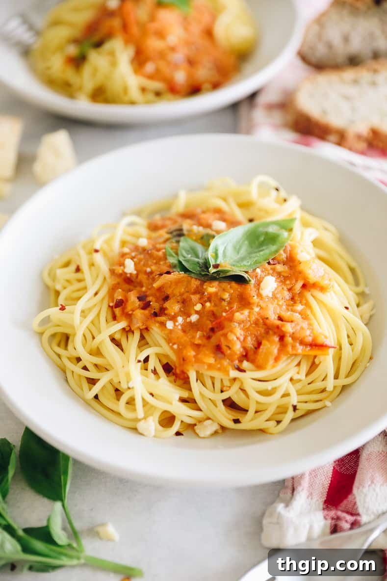 Fiery Homemade Arrabbiata 2 A picture of homemade arrabbiata sauce over spaghetti, garnished with fresh basil.