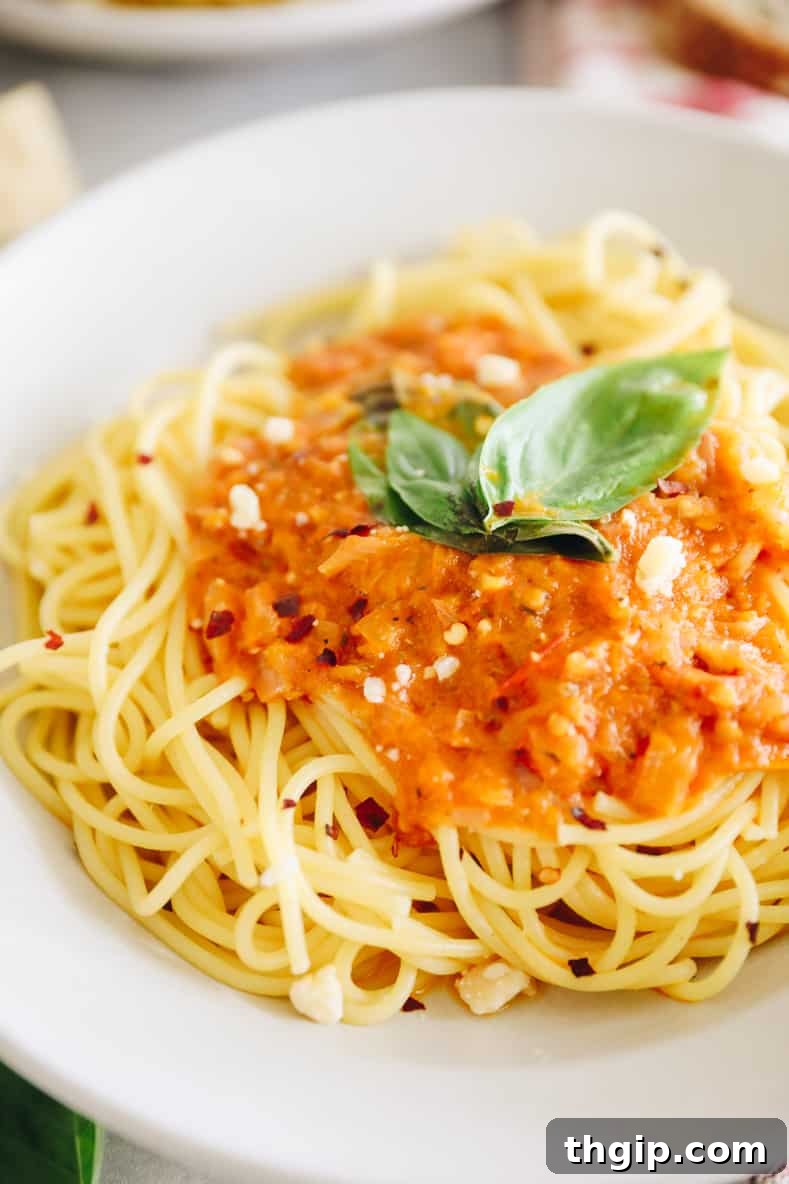 Fiery Homemade Arrabbiata 5 Final plated meal of spicy arrabbiata sauce over spaghetti, ready to be enjoyed.