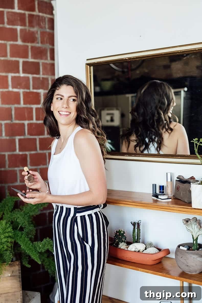 Welcome to Your Green Beauty Haven 2 Smiling woman applying makeup with a brush, showcasing clean beauty