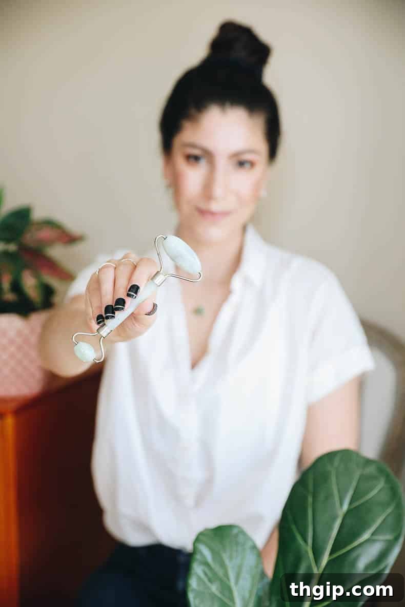 The Jade Roller and Gua Sha Your Path to Radiant Skin 2 woman holding a green jade roller in her hands, showcasing a serene and natural skincare routine.