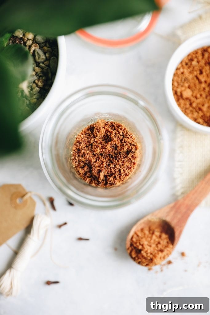 A collection of homemade beauty products including rosewater spray, candles, deodorant, and yoga mat spray.