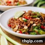 A vibrant bowl of freshly made Veggie Pad Thai with rice noodles and colorful vegetables.