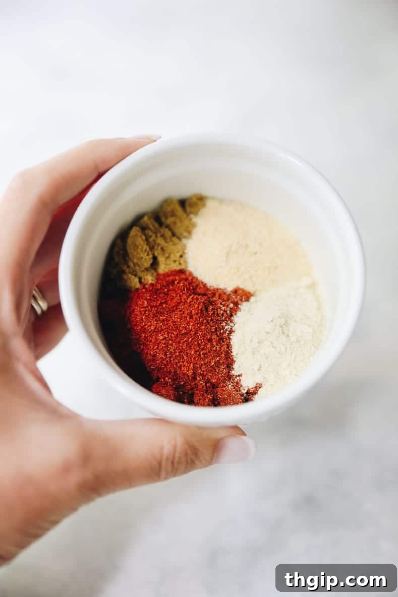 Assortment of spices for enchilada sauce, including chili powder, cumin, garlic powder, and onion powder.