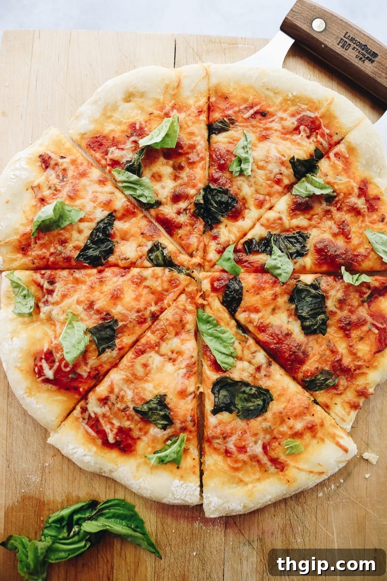 Perfect Homemade Pizza Dough Recipe 4 Two slices of delicious homemade Margherita pizza with fresh basil on a cutting board