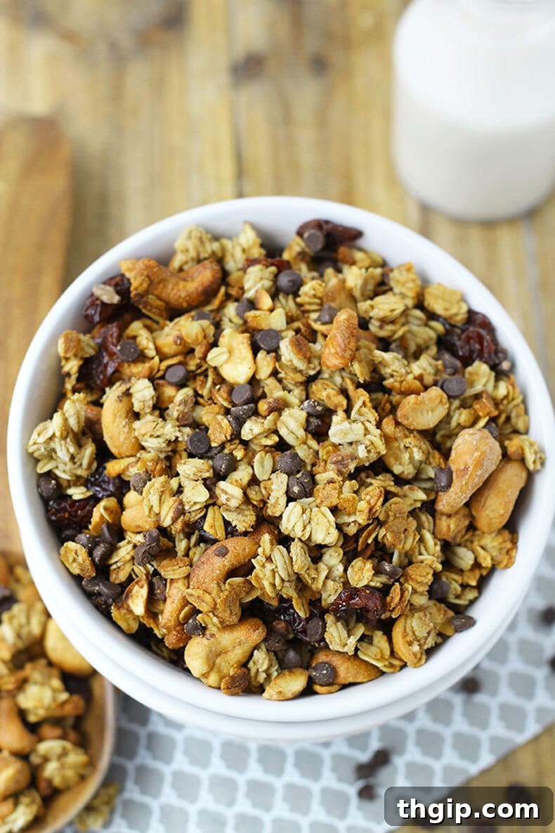 Crimson Cherry Chocolate Granola 2 Freshly baked homemade chocolate cherry granola spread on a baking sheet, ready to cool.
