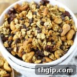 A small bowl of chocolate cherry granola with a spoon.