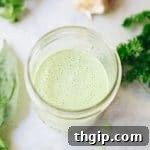 Green Goddess Dressing in a small bowl, garnished with herbs.