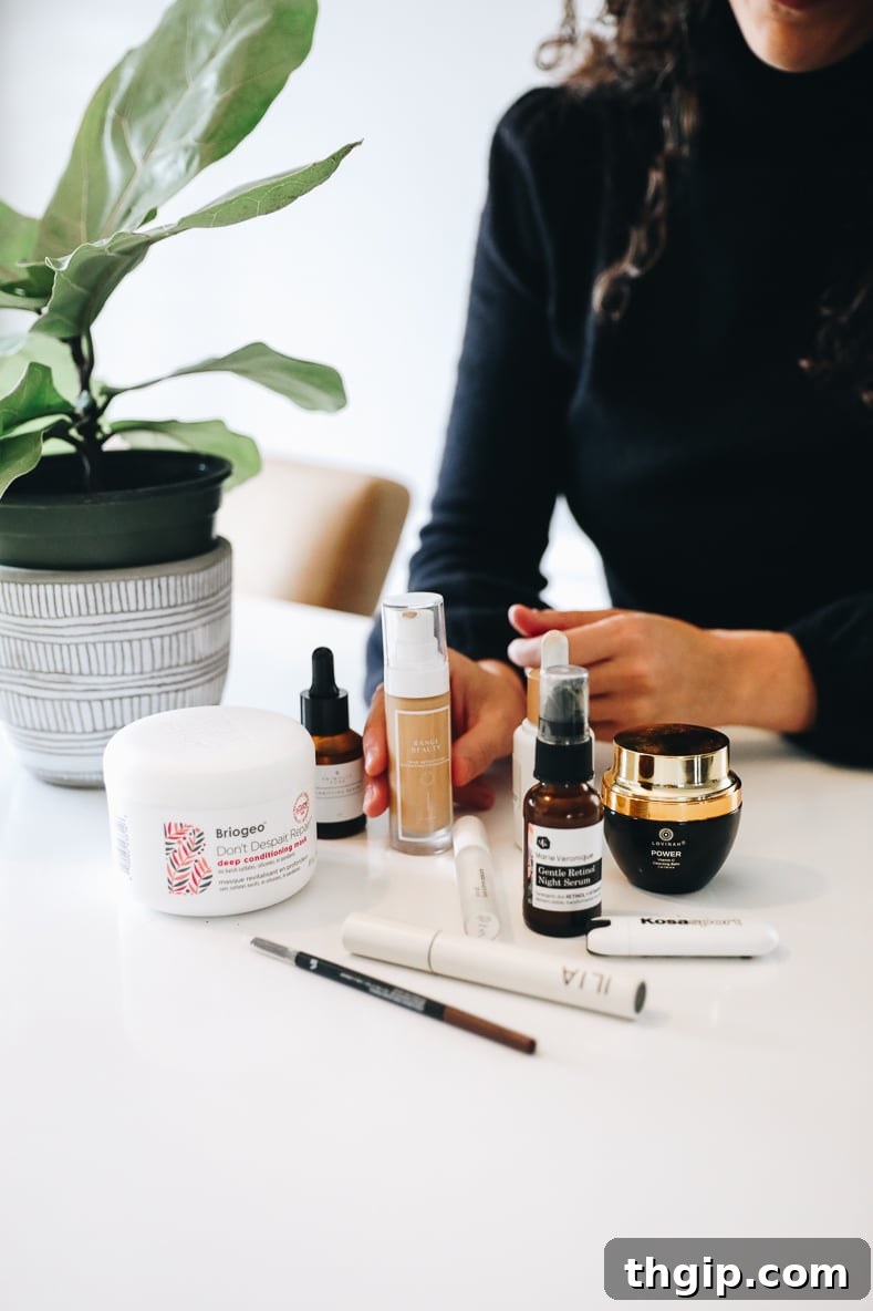 A curated selection of clean beauty products, including makeup and skincare, neatly arranged on a white surface.