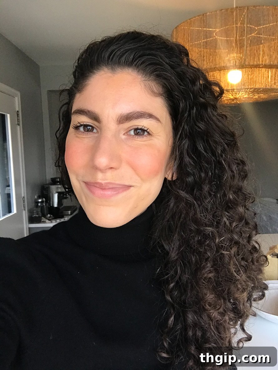 A close-up selfie of a woman wearing a natural, clean beauty makeup look.