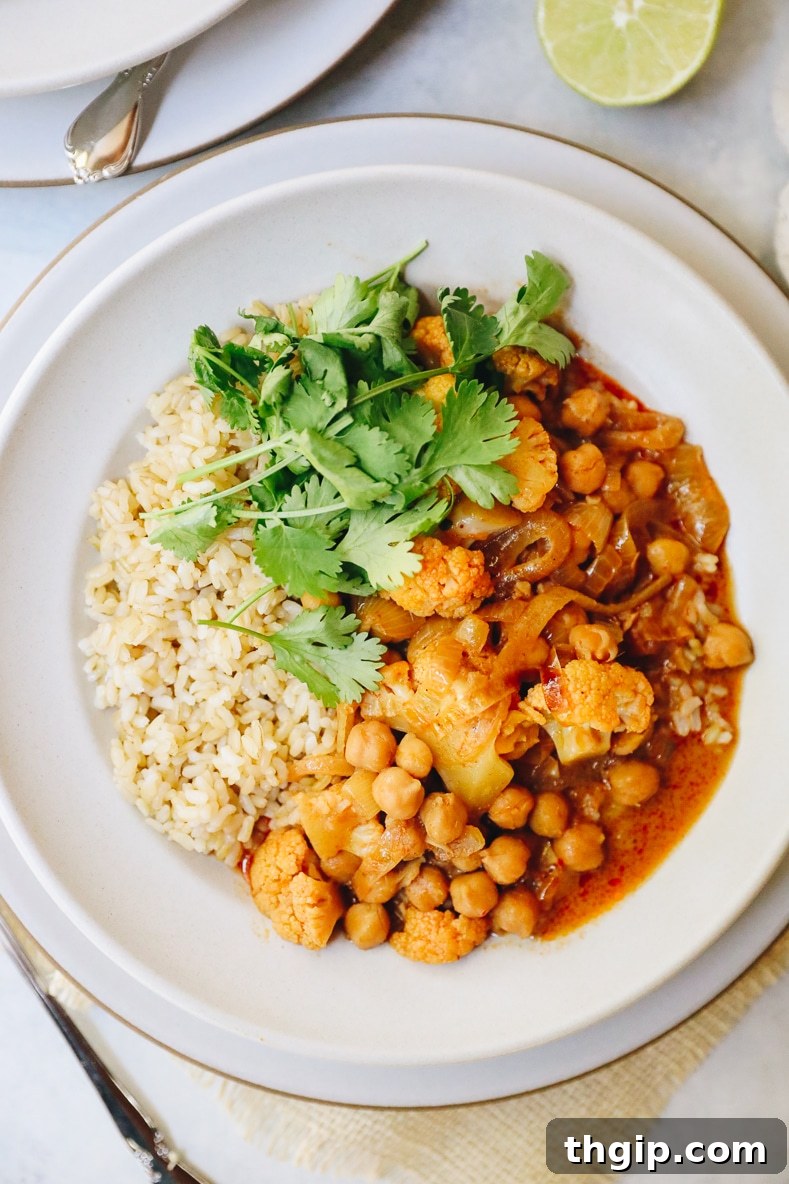 A close-up of the finished Veggie Massaman Curry, showcasing the rich texture of the sauce and the tender vegetables.