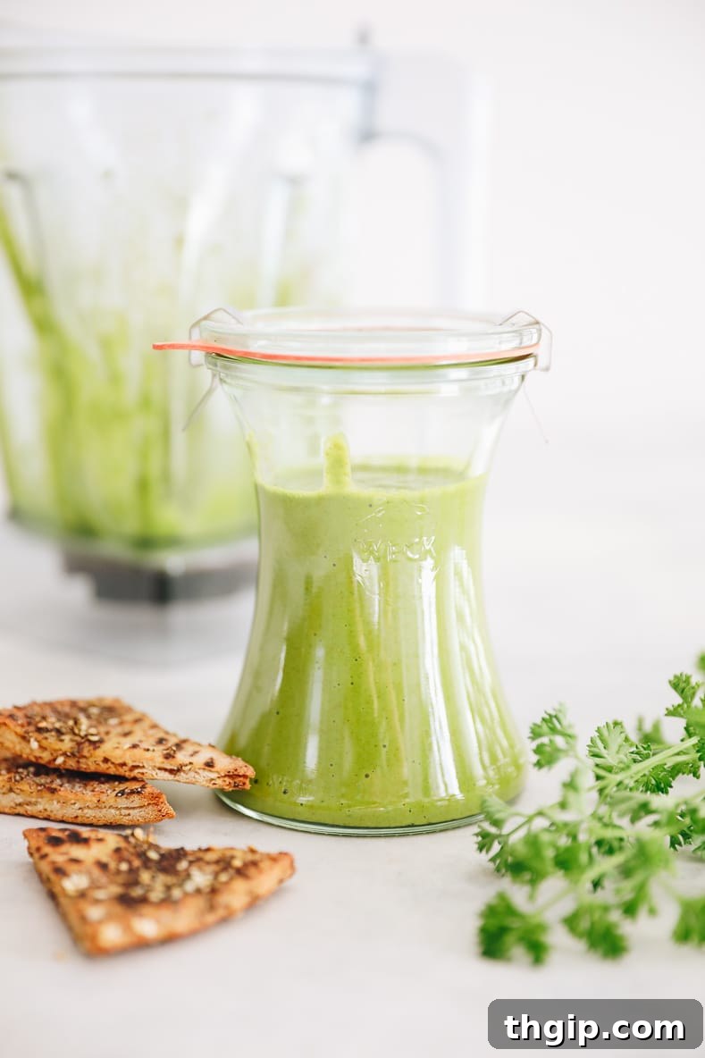 Whip Up Your Own Zhug Skhug Yemeni Hot Sauce 2 Freshly prepared green Zhug sauce in a glass jar, showcasing its vibrant color and texture.