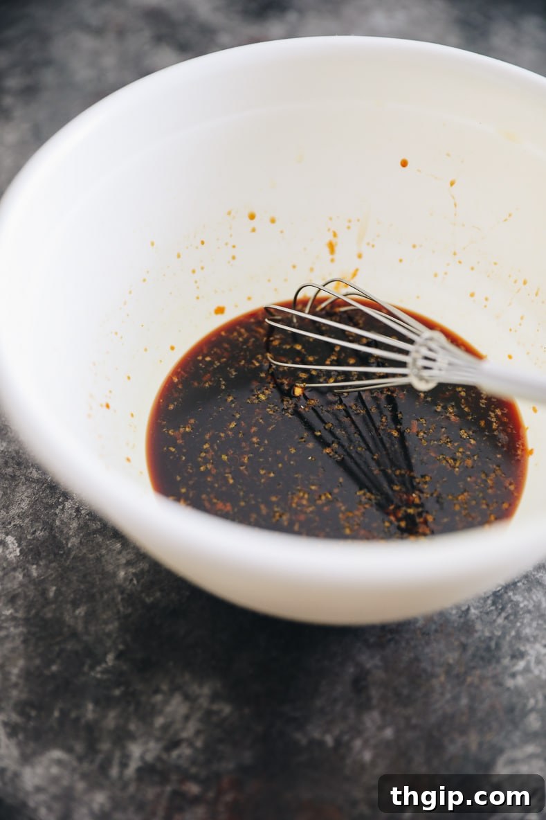 Orange sesame sauce being whisked in a bowl