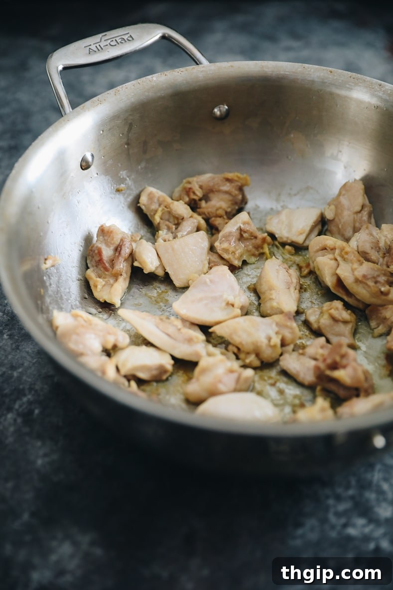 Chicken thighs cooking in a pan